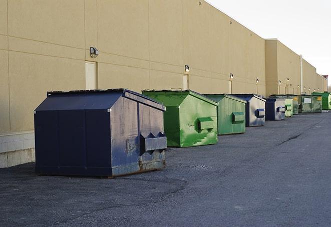 metal waste containers sit at a busy construction site in Denton